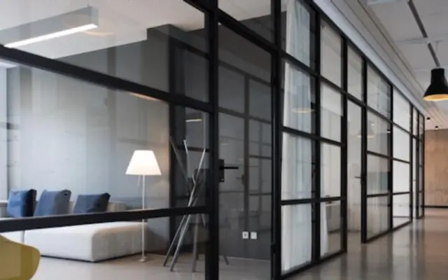 Office hallway lined with glass-walled rooms